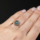 2.40ct Oval Cabochon Montana Sapphire and Antiqued Six Prong Low Profile Halo Ring in 14k Yellow Gold on hand