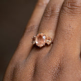 1.45ct Oval Sunstone Three Stone Antique Low Profile Ring in 14k Rose Gold on the hand