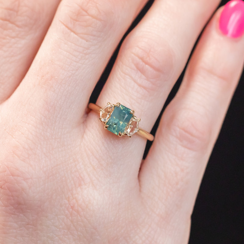 1.47ct Radiant Opalescent Teal Sapphire and White Sapphire Three Stone Ring in 14k Yellow Gold