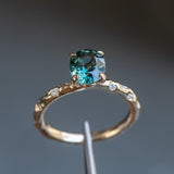 1.79ct Oval Blue Color Changing Sapphire in 14k Yellow Gold Evergreen Solitaire with Scattered Embedded Diamonds
