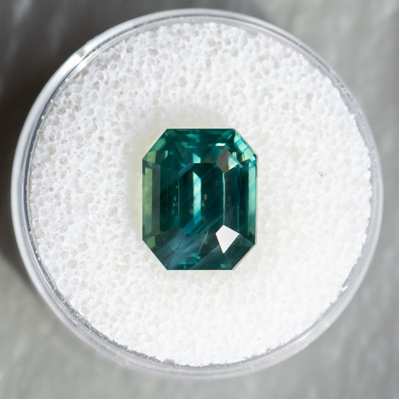 7.08CT EMERALD CUT MADAGASCAR SAPPHIRE, DEEP GREEN TEAL WITH COLOR ZONING, 11.17X9.07X7.07MM