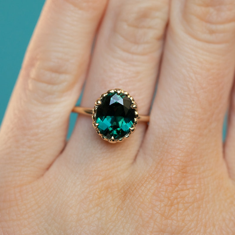 3.17ct Teal Oval Madagascar Sapphire Scallop Cup Sapphire Solitaire in 14K Yellow Gold on hand