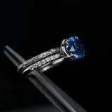 3.18ct Round Periwinkle Sapphire Solitaire with Diamonds in Platinum in tweezers with evergreen band