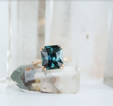 5.67ct Radiant Cut Teal Sapphire Ring with French Set Diamond Studded Band in 18k Rose Gold
