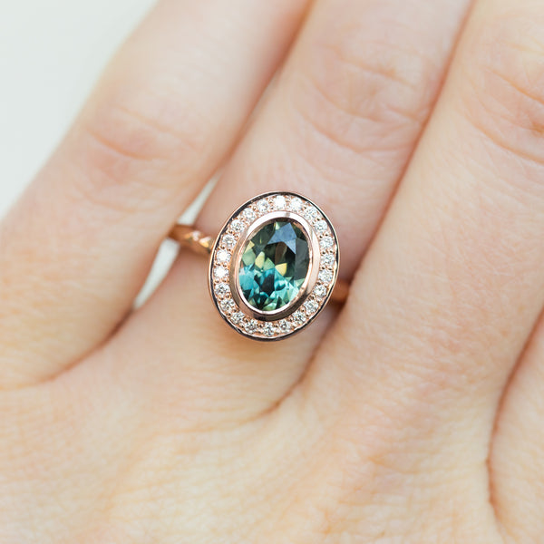 Oval Bezel Set 1.49ct Color Changing Teal Sapphire and Diamond Halo Engagement Ring - 14k Rose Gold Evergreen Band