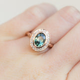 Oval Bezel Set 1.49ct Color Changing Teal Sapphire and Diamond Halo Engagement Ring - 14k Rose Gold Evergreen Band