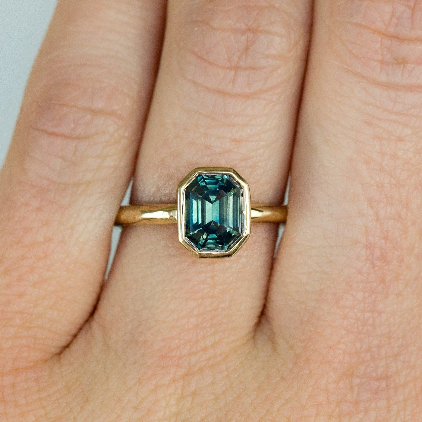 Light Teal Emerald Cut Sapphire Bezel Evergreen Setting 14k