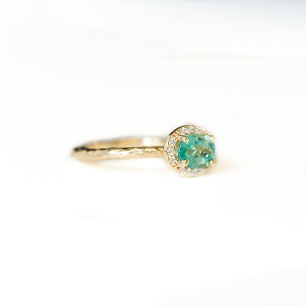 Neon Emerald East-West Oval Halo Ring in Evergreen Carved Yellow Gold