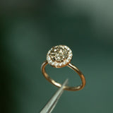 1.85ct GIA Crown Jubilee® Diamond Six Prong Halo Ring in 14k Yellow Gold angled in tweezers