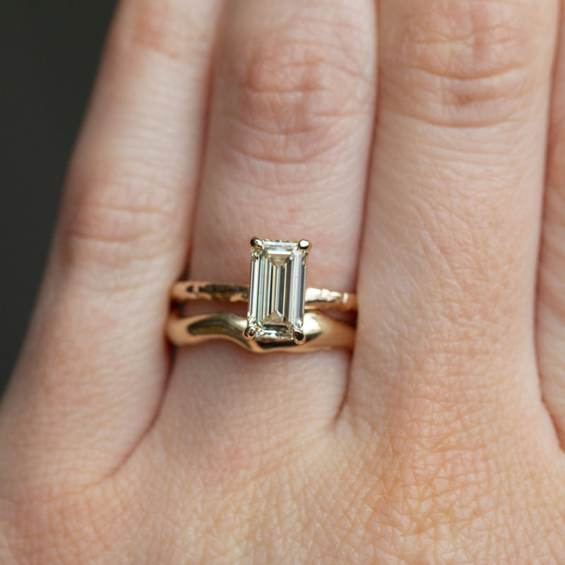 1.30ct Light Champagne Emerald Cut Diamond Solitaire Evergreen Ring In 14k Yellow Gold on hand with organic alluvial band