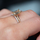 1.30ct Light Champagne Emerald Cut Diamond Solitaire Evergreen Ring In 14k Yellow Gold on hand with diamond band
