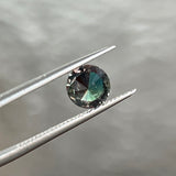 1.17CT BRILLIANT ROUND MADAGASCAR SAPPHIRE, COLOR SHIFTING TEAL TO PURPLE RED WITH OLIVE GREEN FLASHES, 6.65X3.70MM