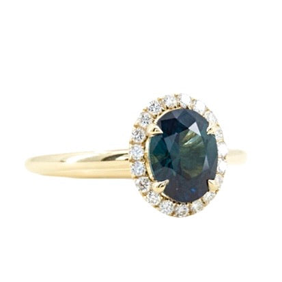 1.55ct Oval Blue Nigerian Sapphire and Diamond Four Prong Halo Ring in 14k Yellow Gold side angle